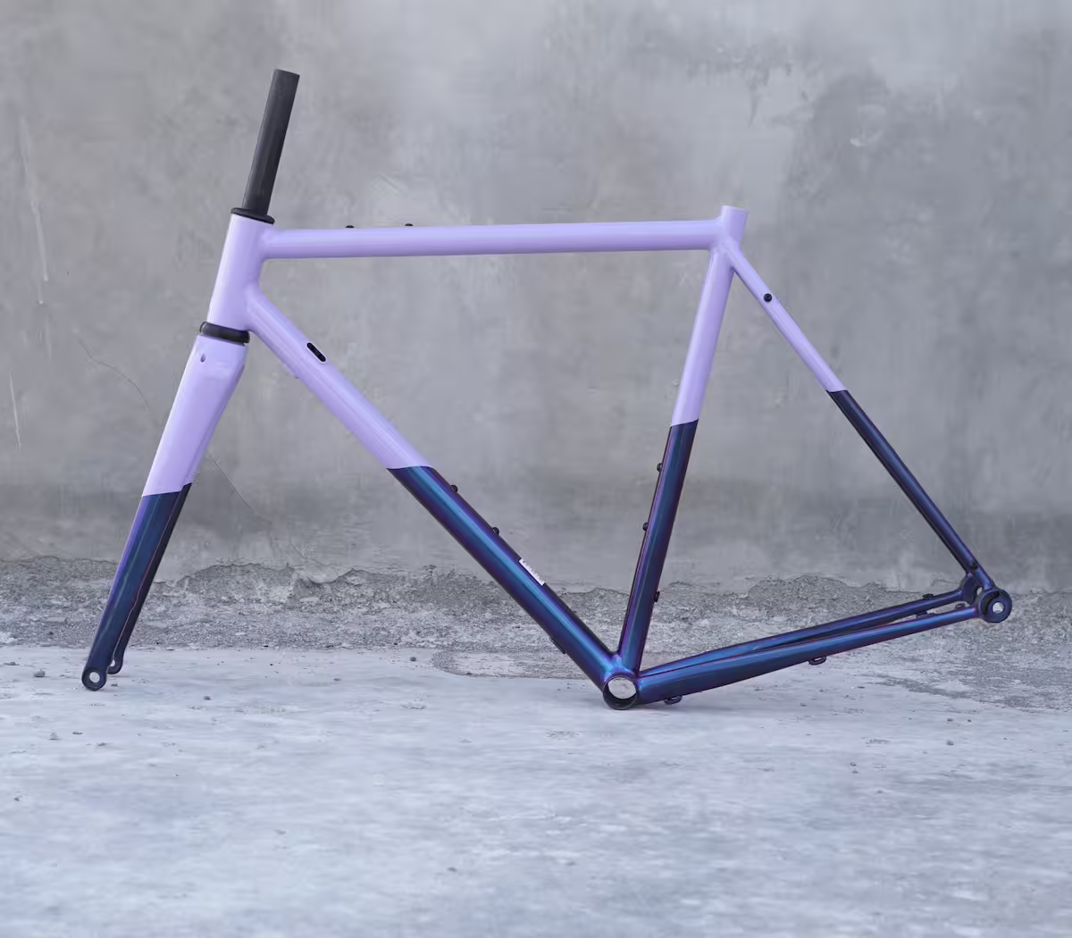 A purple bike frame on a concrete background